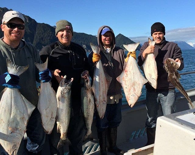 Salmon-Halibut-Fishing people in Alaska holding salmon and halibut